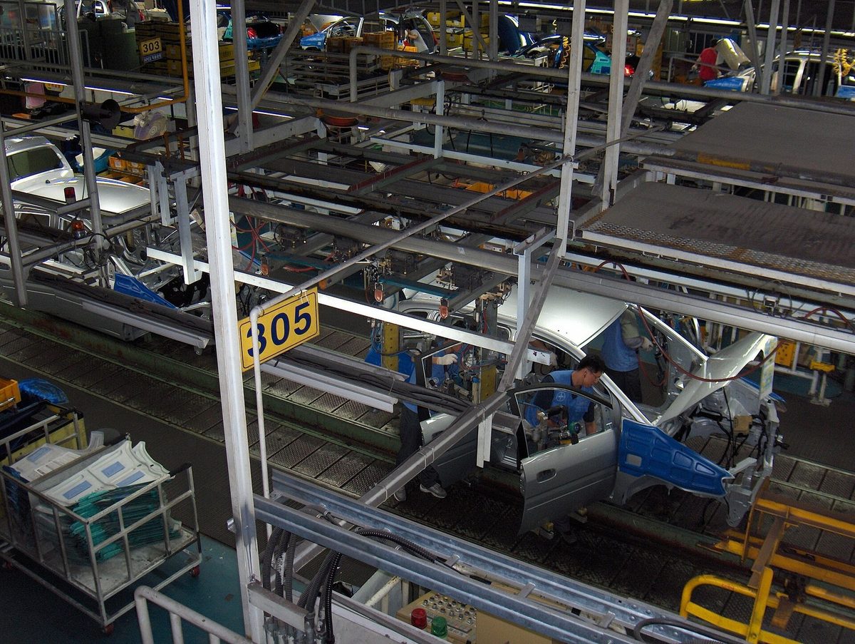 Looking down onto a car assembly line from a walkway